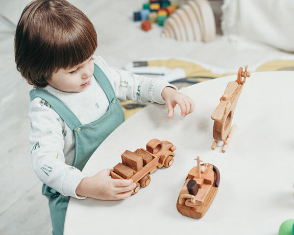 wood toys | child therapy in Baltimore, MD | play therapy | child therapist | children's therapy | 21045 | 21737 | 21227 | 20854 Image of a child using play therapy as a part of children's therapy in Maryland. Whether you are in Columbia, Baltimore, or the Washington DC area you kid could benefit from child therapy so they can gain support from a child therapist.