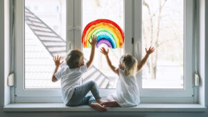 rainbow | child therapy in the Washington DC area | play therapy in the Washington DC area | children's therapy in Maryland | 20854 | 20818 | 20817 Image of kid touching a rainbow painted on a window. Showing how through child therapy in the Washington DC area your child can start to shine. Painting and play therapy can help foster communication in children's therapy in Maryland.