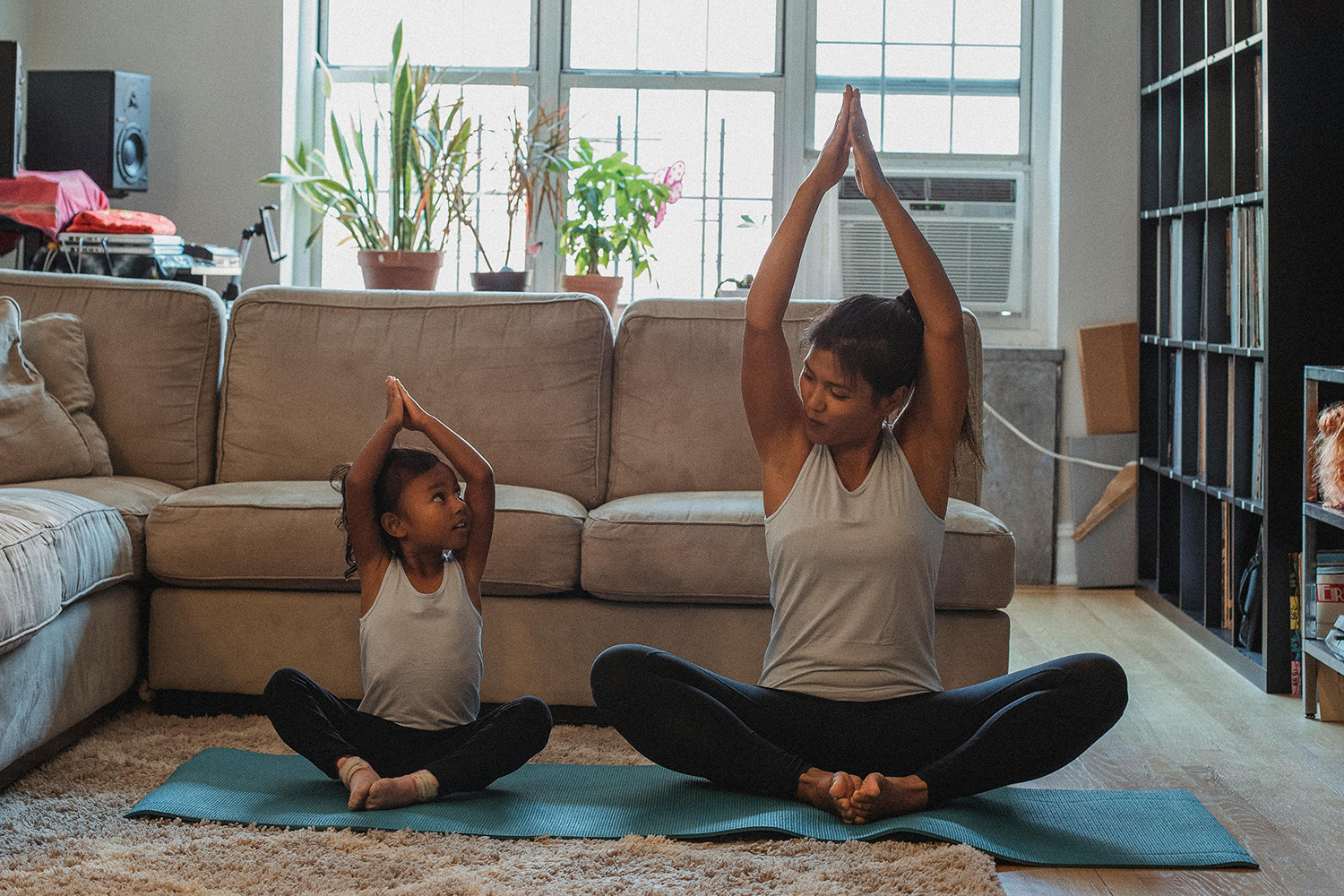 Mother and child doing yoga to manage child anxiety